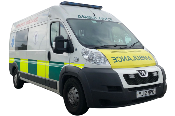White emergency ambulance with green and yellow reflective stripes, parked with no visible people.
